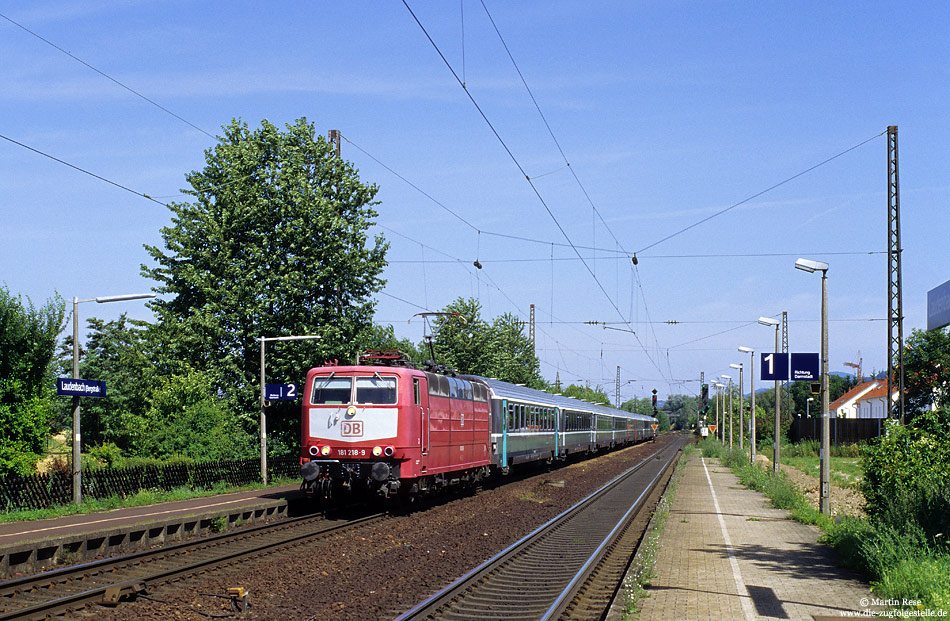 181 218 in orientrot mit dem aus Französichen Wagen gebildeten EC54 in Laudenbach mit alten Bahnsteigen