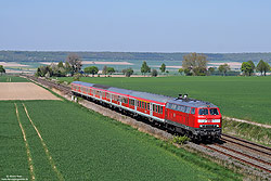 Abschlepplokomotive 218 822 in verkehrsrot mit Regionalexpress im Vorharz bei Baddeckenstedt