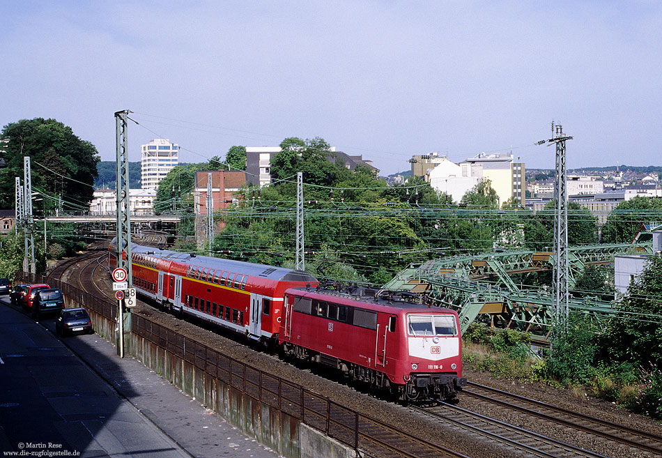111 116 in orientrot mit RE11407 Aachen - Münster bei Wuppertal Hbf mit Schwebebahn